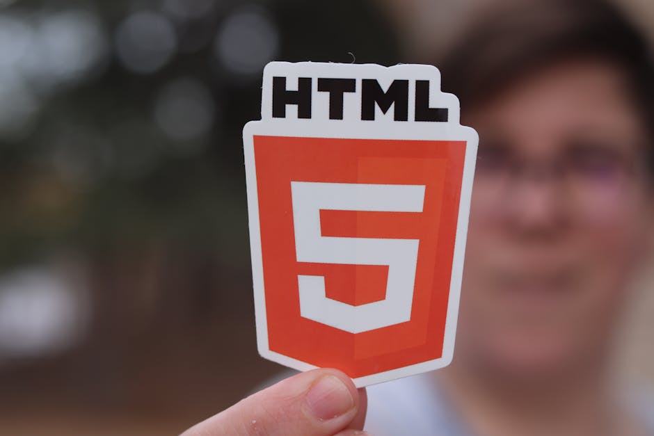 A close-up view of a computer screen displaying HTML code, including tags such as <html>, <head>, <title>, and <meta>; the lines of code are illuminated with a soft glow in a dark environment, indicat